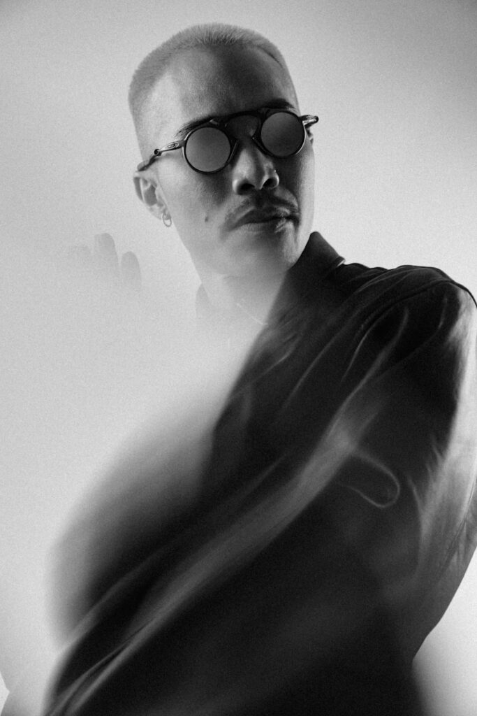 Man with glasses and mustache looking away